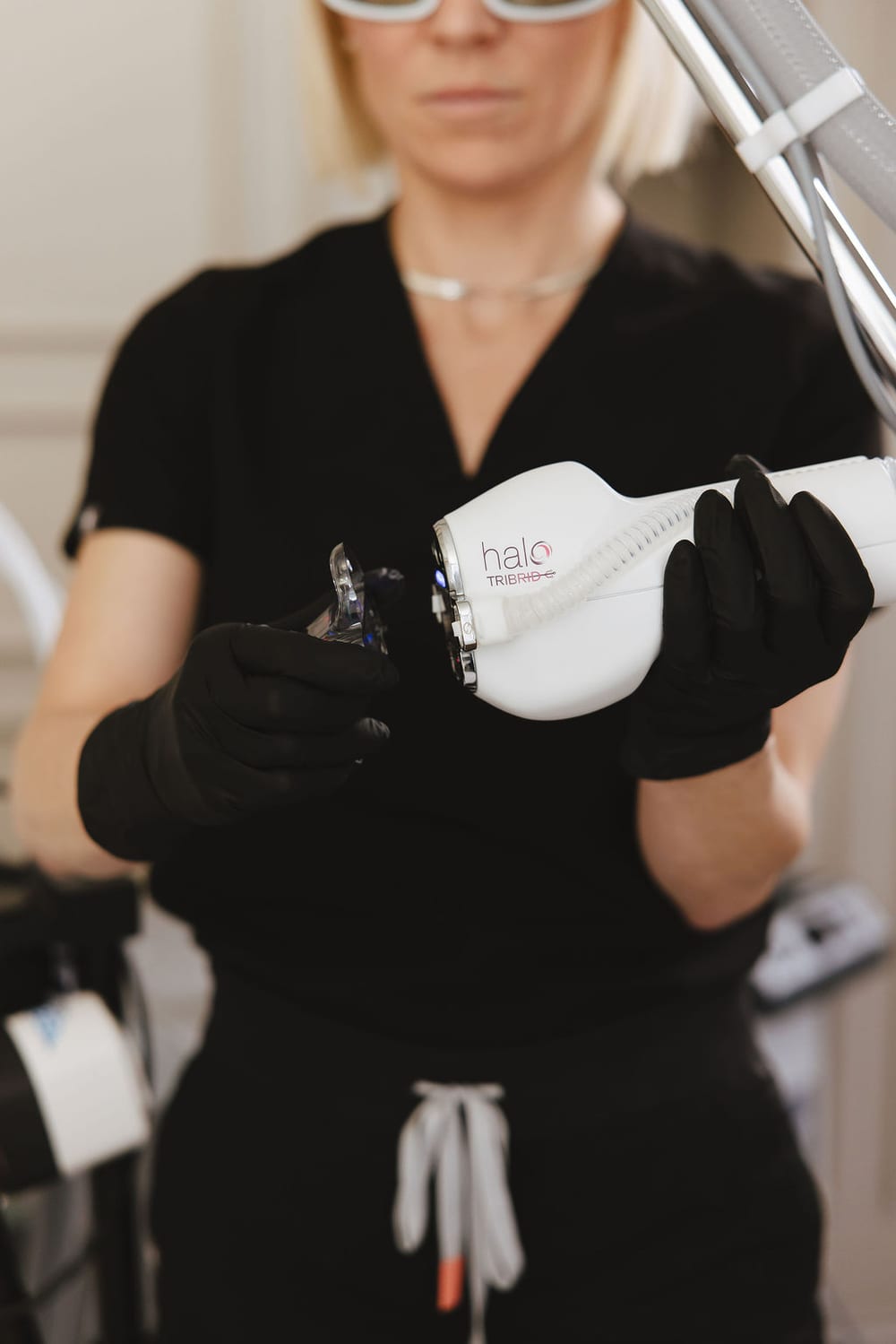 Provider holding the HALO TRIBRID handpiece at Treasure Valley Medical Spa